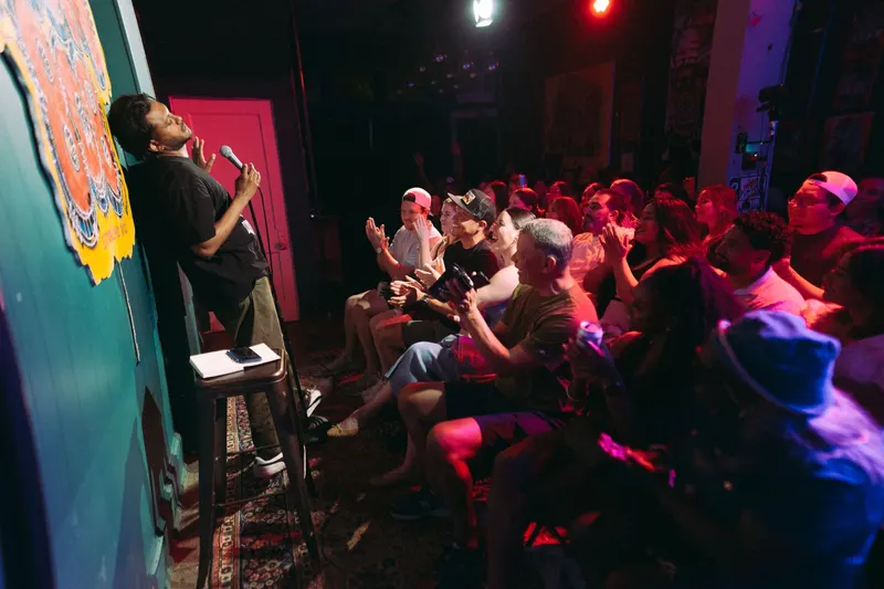 A packed Room 808 crowd clapping